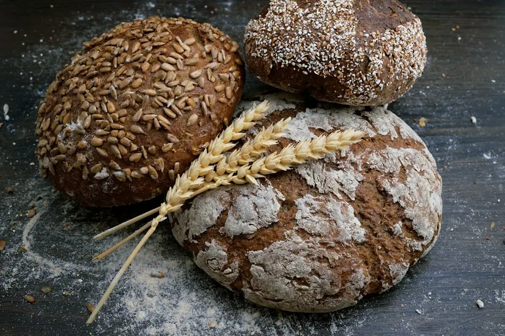 Rustic sourdough loaves on a dark board